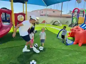 Children playing soccer in OC Kids Preschool enrichment program